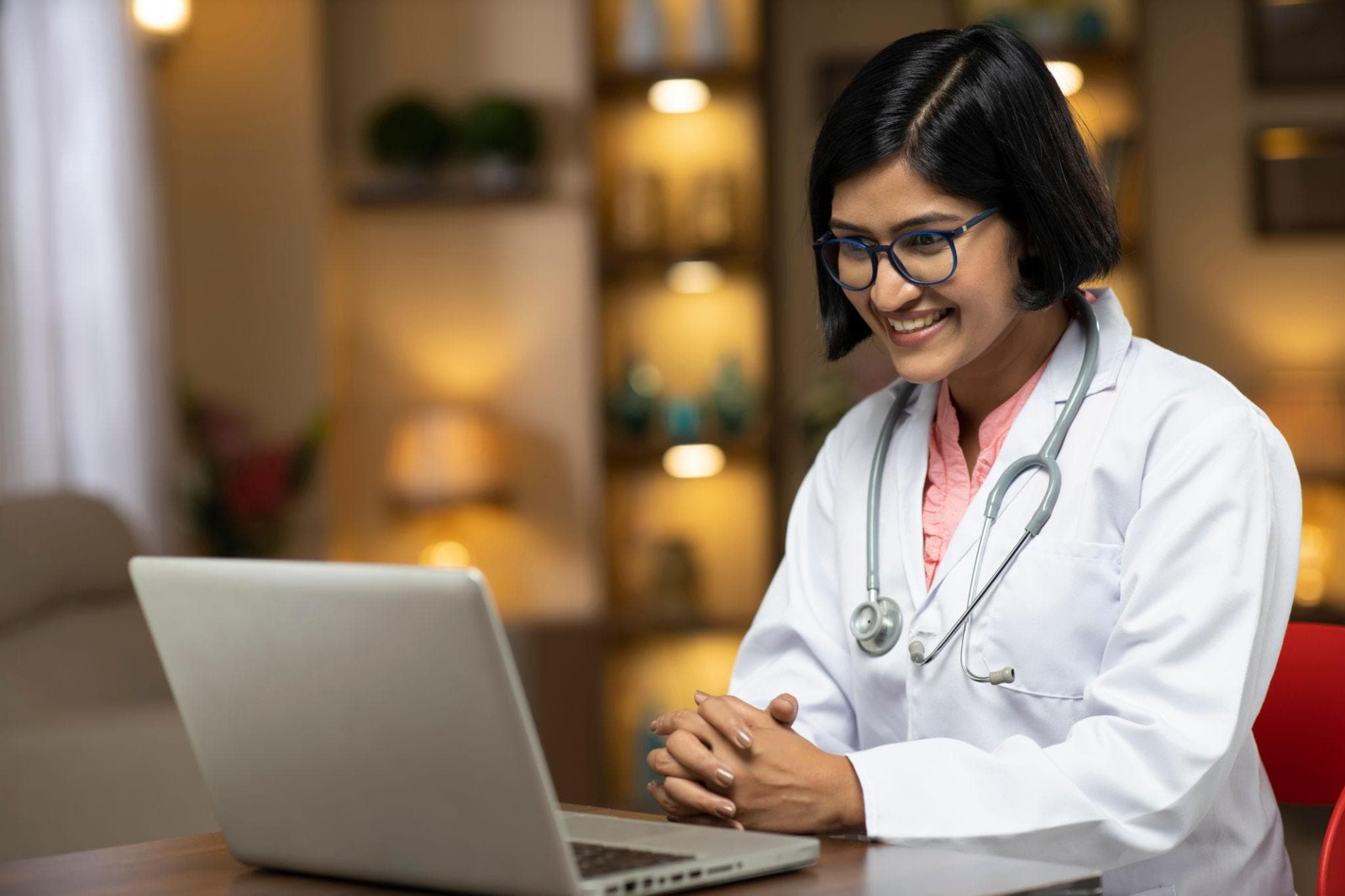Online Counseling for Healthcare Professionals  counselling for doctors Doctor attending an online counseling session through a laptop from a comfortable home environment after work.