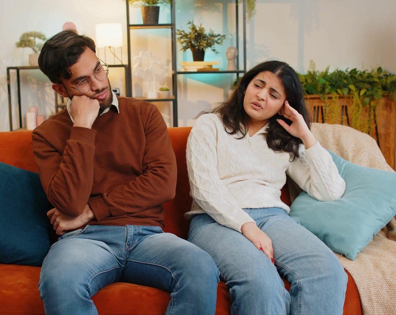 A couple sitting together but struggling to communicate, with subtle serious expressions rather than dramatic anger. Couples Marriage Counseling for Better Understanding A couple sitting together but struggling to communicate, with subtle serious expressions rather than dramatic anger. Couples Marriage Counseling for Better Understanding